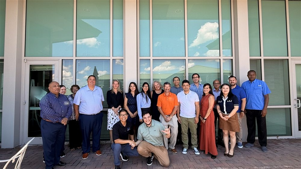 Students and faculty gathered outside a building at Florida Gulf Coast University
