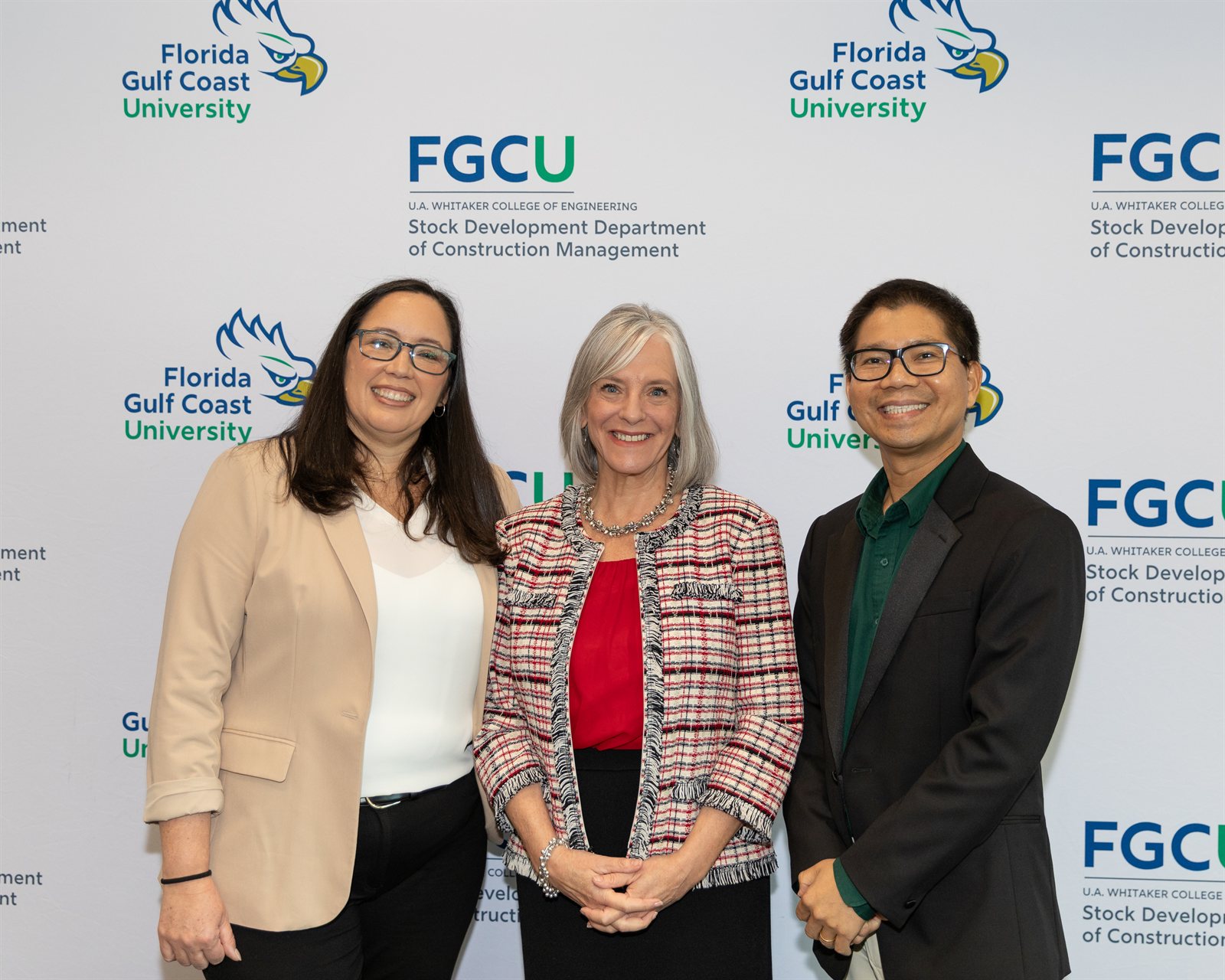 Dr. Nguyen and two colleagues in front of the FGCU Construction Management backdrop