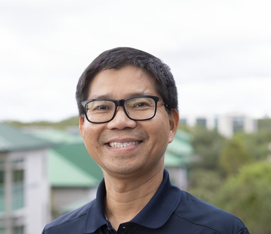 Dr. Long Nguyen smiling in a navy polo shirt